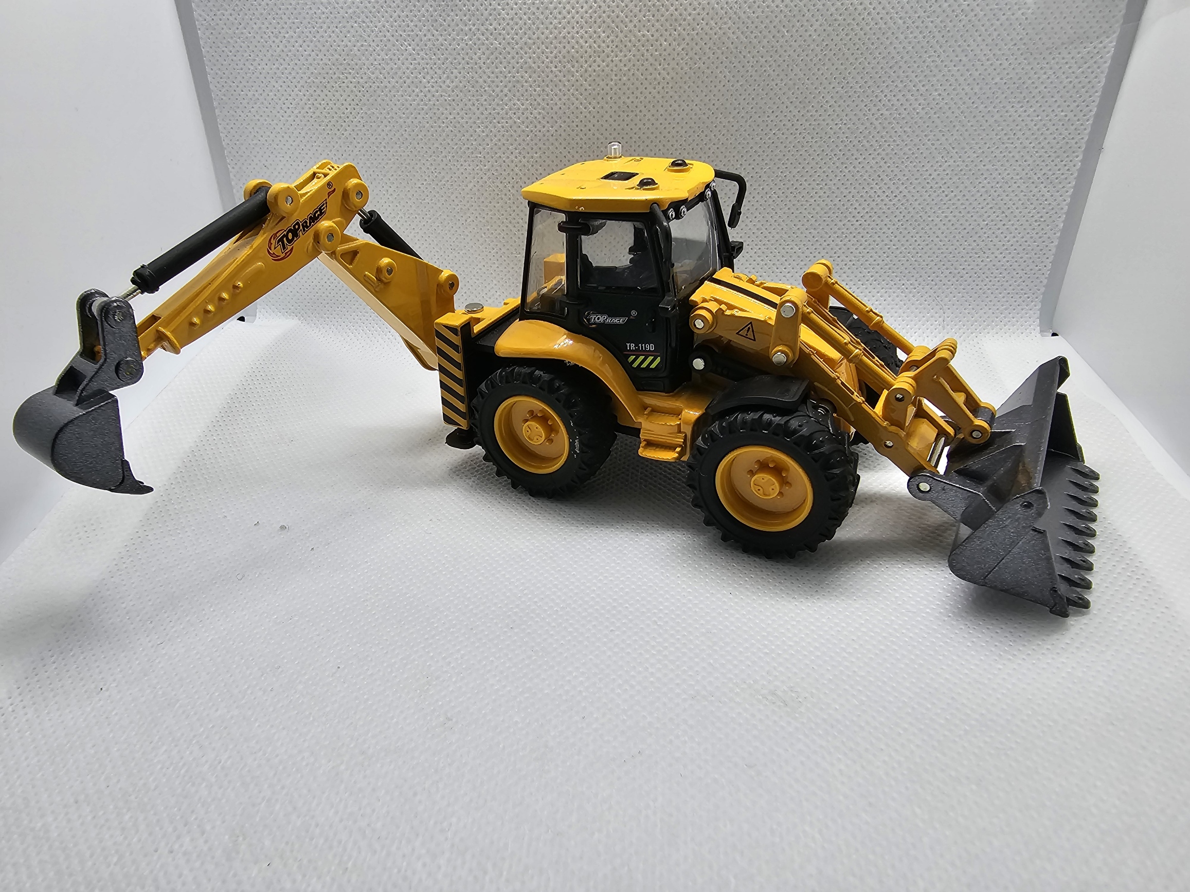 Yellow backhoe loader toy